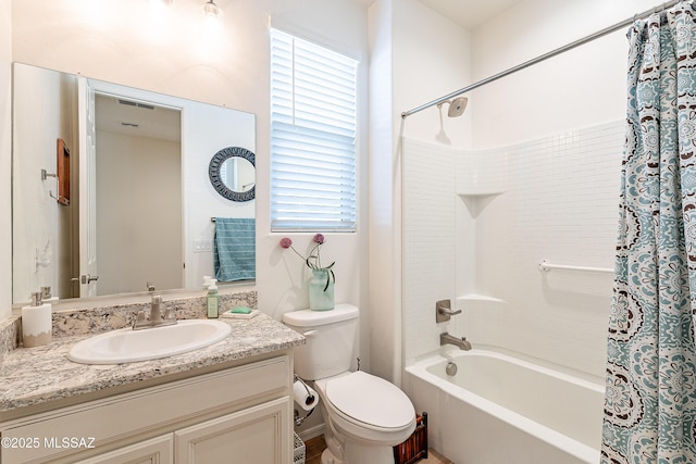 bathroom featuring shower / tub combo with curtain, vanity, and toilet