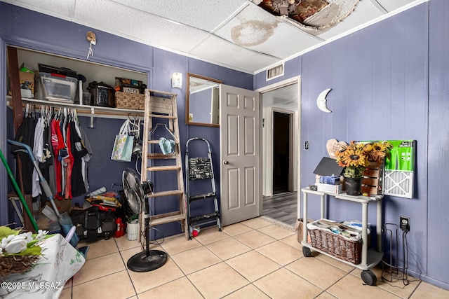 interior space featuring a closet, a drop ceiling, and visible vents