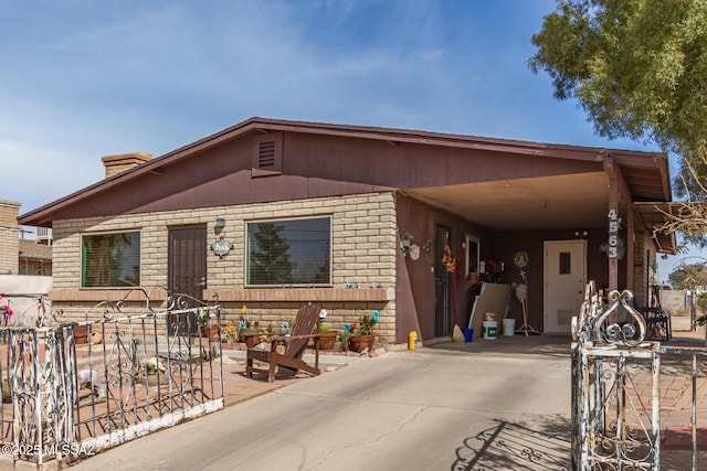 manufactured / mobile home featuring brick siding and driveway