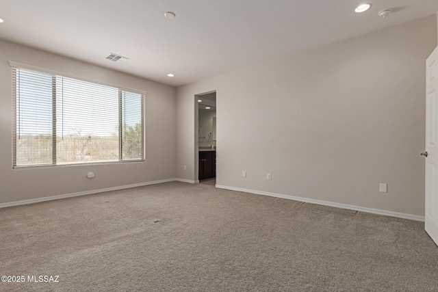 empty room with recessed lighting, visible vents, light carpet, and baseboards