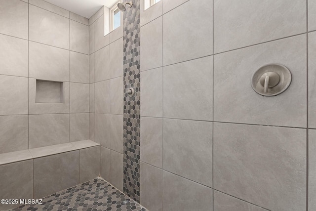 full bath with tiled shower