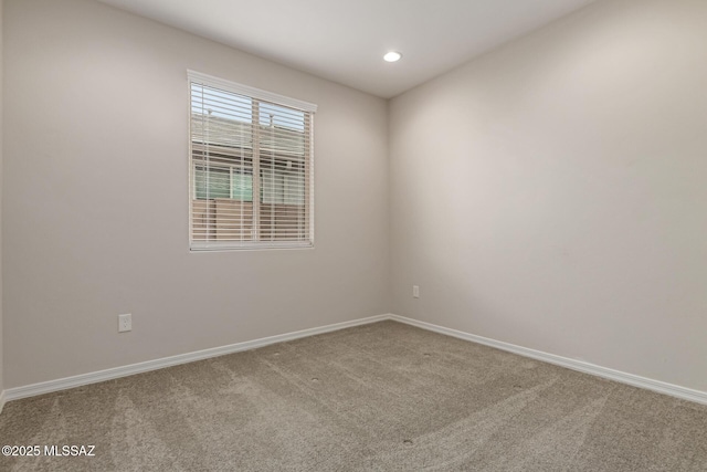 spare room featuring carpet, baseboards, and recessed lighting