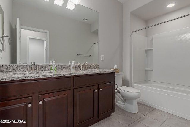 bathroom with bathing tub / shower combination, tile patterned flooring, a sink, and toilet