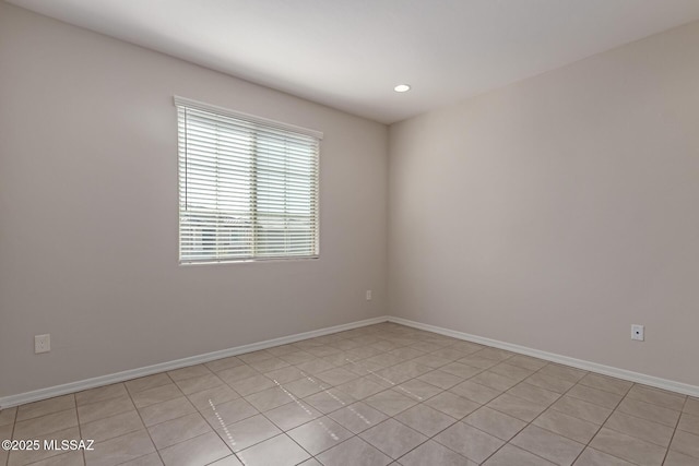 unfurnished room with baseboards and recessed lighting