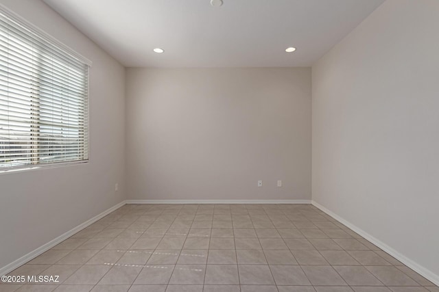 unfurnished room with recessed lighting and baseboards