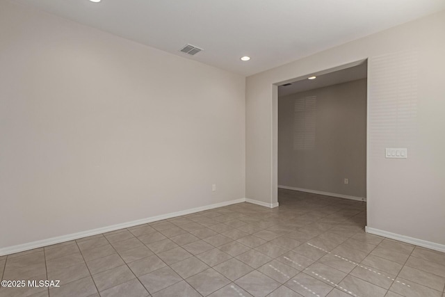 unfurnished room with recessed lighting, visible vents, and baseboards