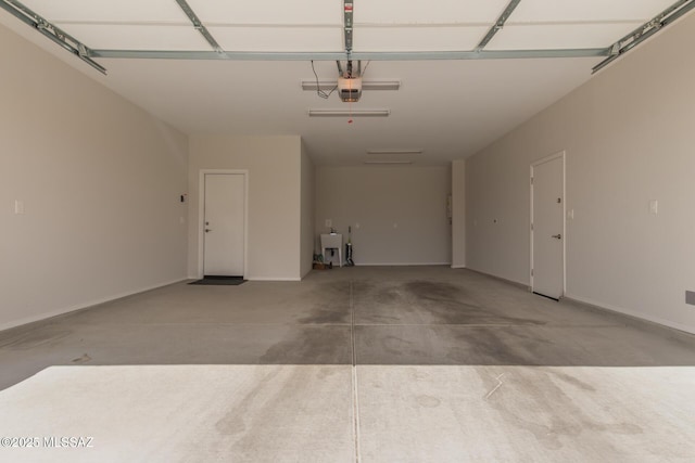 garage with baseboards and a garage door opener