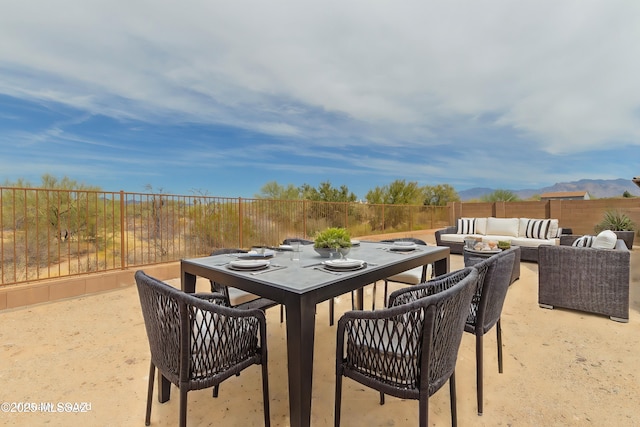 view of patio featuring outdoor dining area, a fenced backyard, and an outdoor living space