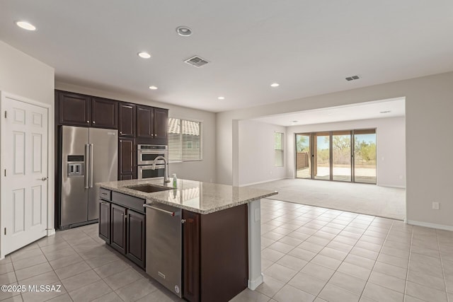 kitchen with open floor plan, stainless steel appliances, a sink, and visible vents