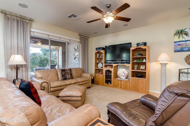 living room featuring carpet, visible vents, and a ceiling fan