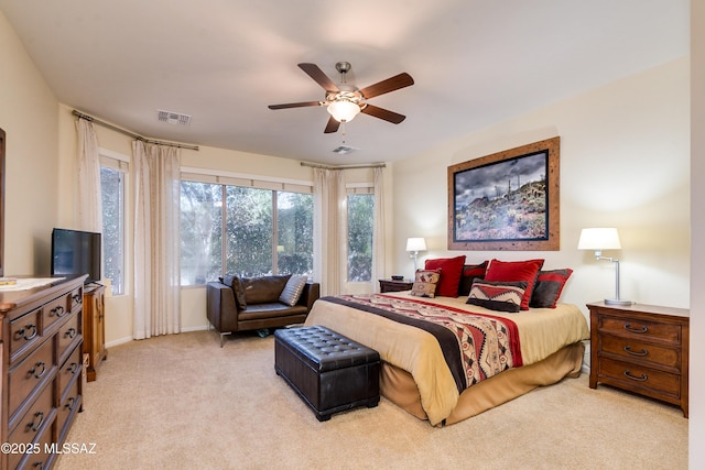 bedroom featuring ceiling fan, visible vents, and light colored carpet