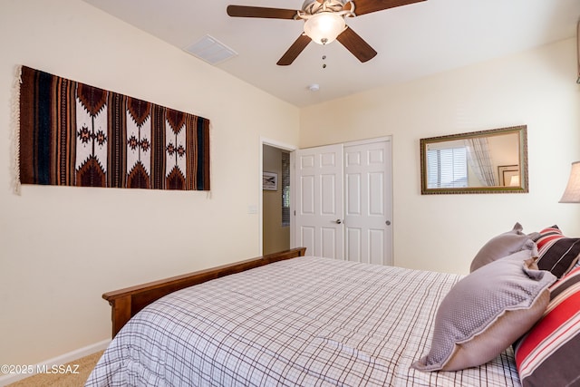 bedroom with carpet floors, a closet, visible vents, ceiling fan, and baseboards