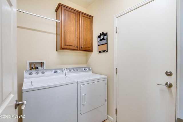 laundry room with cabinet space and independent washer and dryer