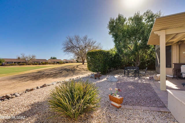 view of yard with outdoor dining area and a patio area