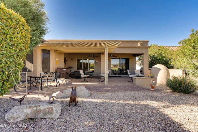 back of house featuring ceiling fan, a patio area, and stucco siding