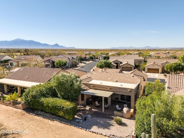 birds eye view of property with a mountain view and a residential view