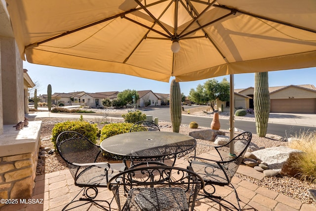 view of patio / terrace featuring a residential view and outdoor dining area