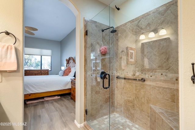 bathroom featuring ensuite bath, wood finished floors, and a stall shower