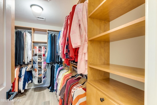 spacious closet with wood finished floors and visible vents