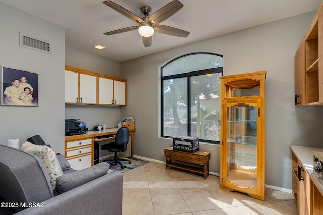 office with visible vents, a ceiling fan, light tile patterned floors, baseboards, and built in study area