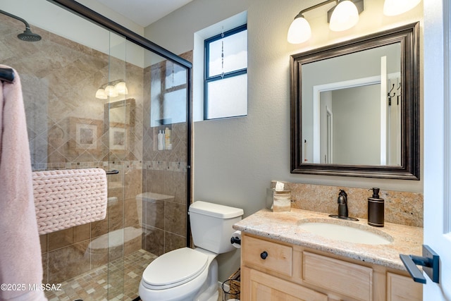 full bath with toilet, a shower stall, and vanity