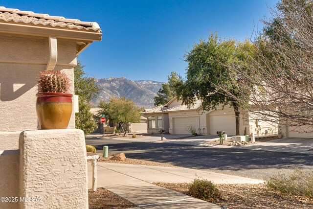 exterior space featuring a mountain view and driveway