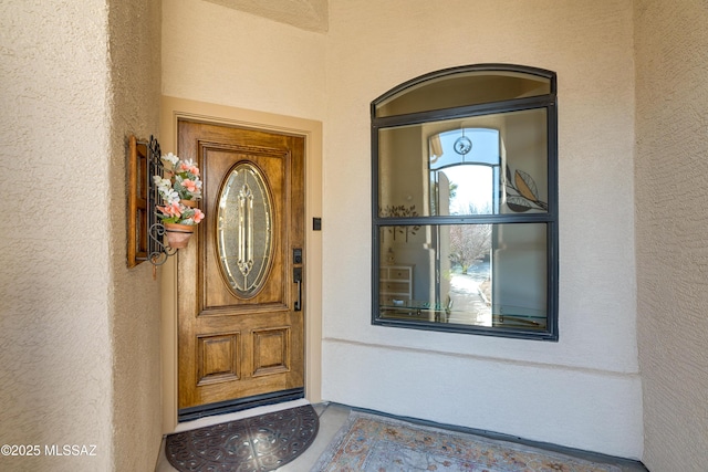 entrance to property with stucco siding