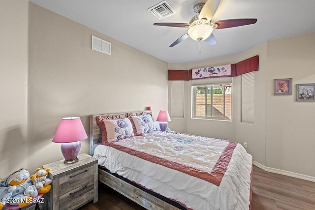 bedroom featuring baseboards, visible vents, and dark wood-style flooring