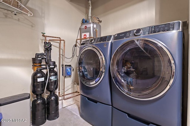 laundry room featuring separate washer and dryer, water heater, and laundry area