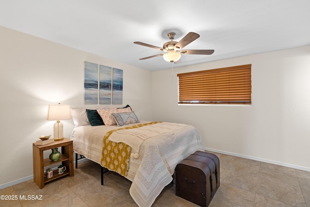 bedroom with ceiling fan and baseboards