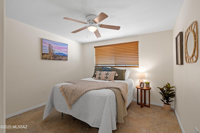 bedroom with a ceiling fan and baseboards