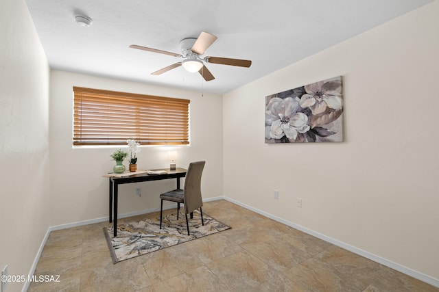 office area with ceiling fan and baseboards