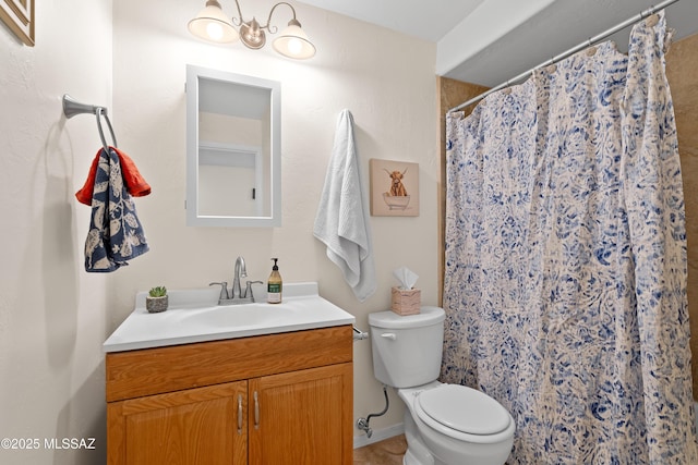 bathroom with curtained shower, vanity, and toilet