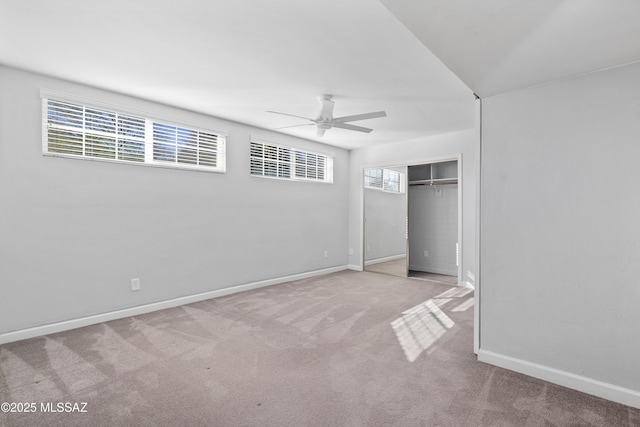 unfurnished bedroom featuring a closet, multiple windows, carpet flooring, and baseboards