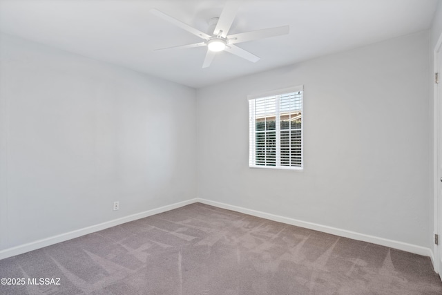 spare room with ceiling fan, carpet, and baseboards