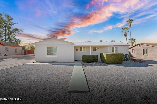 single story home featuring fence and stucco siding