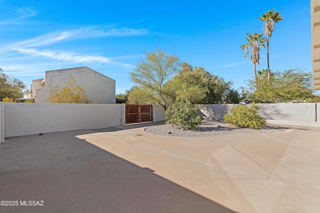 view of patio featuring a gate and fence