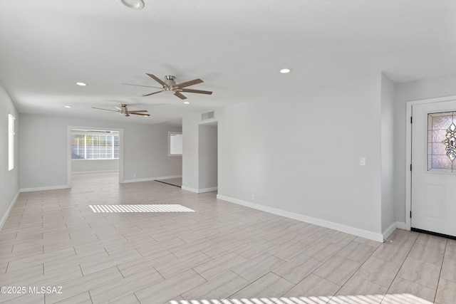 unfurnished living room with ceiling fan, recessed lighting, visible vents, and baseboards