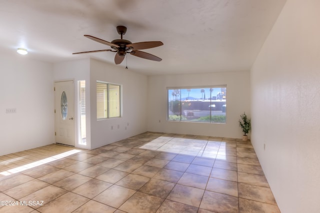 tiled entrance foyer with a ceiling fan