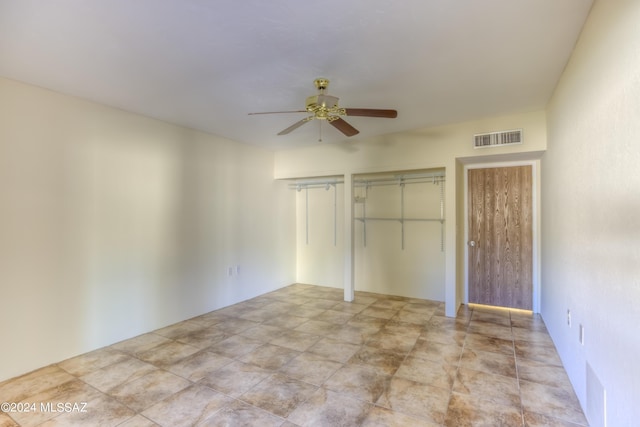 unfurnished bedroom with visible vents and a ceiling fan