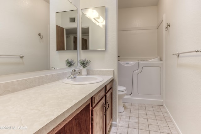 bathroom featuring baseboards, visible vents, toilet, tile patterned floors, and vanity