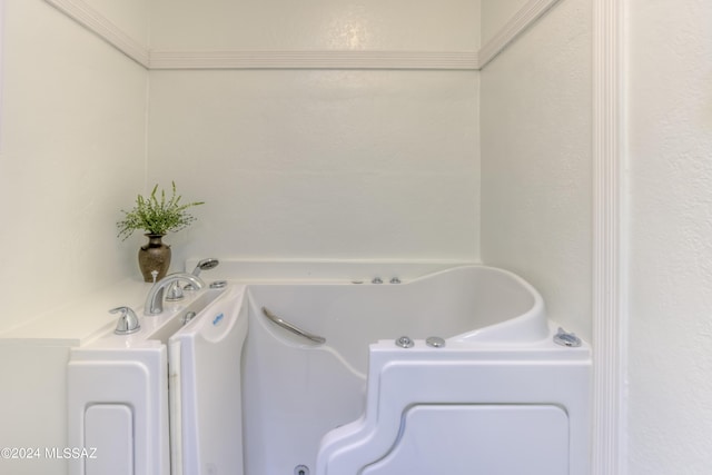 bathroom featuring a tub with jets