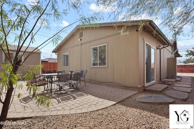 exterior space featuring outdoor dining space and fence