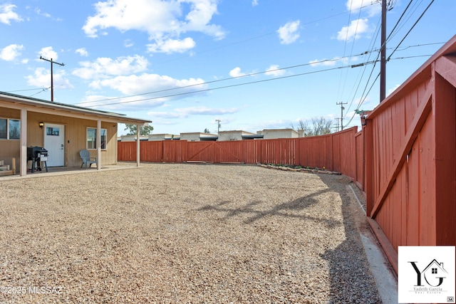 view of yard with a patio area and a fenced backyard