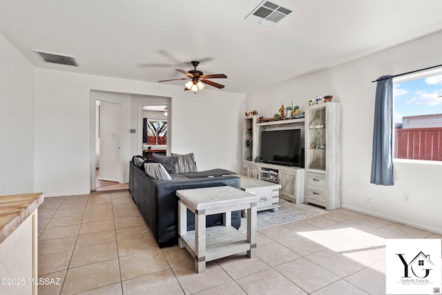 living room with light tile patterned floors, ceiling fan, and visible vents