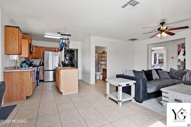 kitchen with visible vents, open floor plan, light countertops, appliances with stainless steel finishes, and stacked washing maching and dryer