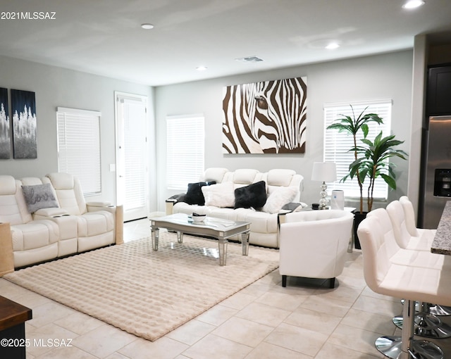 living room with recessed lighting, visible vents, and light tile patterned floors