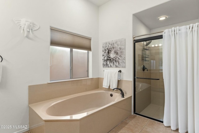 full bathroom featuring tile patterned floors, a shower stall, and a bath