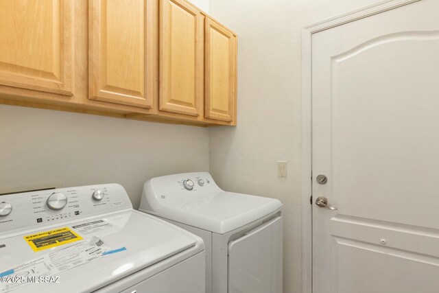 laundry area with cabinet space and independent washer and dryer