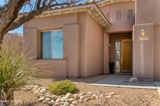 property entrance featuring stucco siding